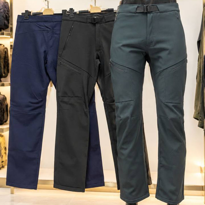 Unisex fleece-lined softshell tactical pants in navy, black, and dark green with built-in belt for outdoor and daily wear.