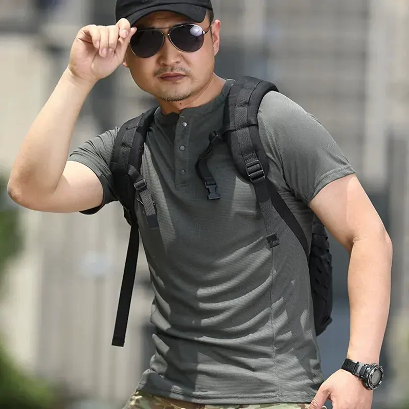 Man wearing TSS17 Men’s Quick-Drying Henley Outdoor T-Shirt in gray with sunglasses and backpack.