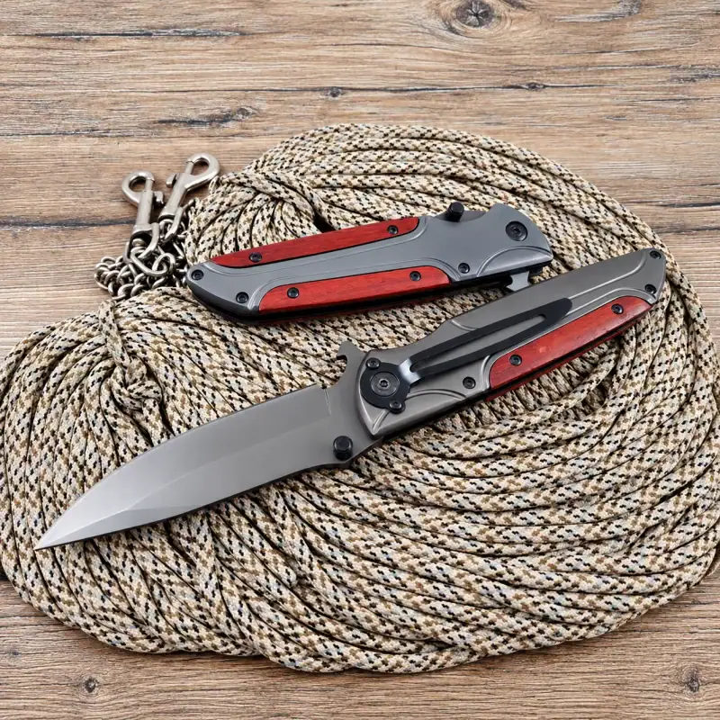 K21 Browning FA50 tactical folding knife with red handles and steel blade, outdoor gear for tactical use.