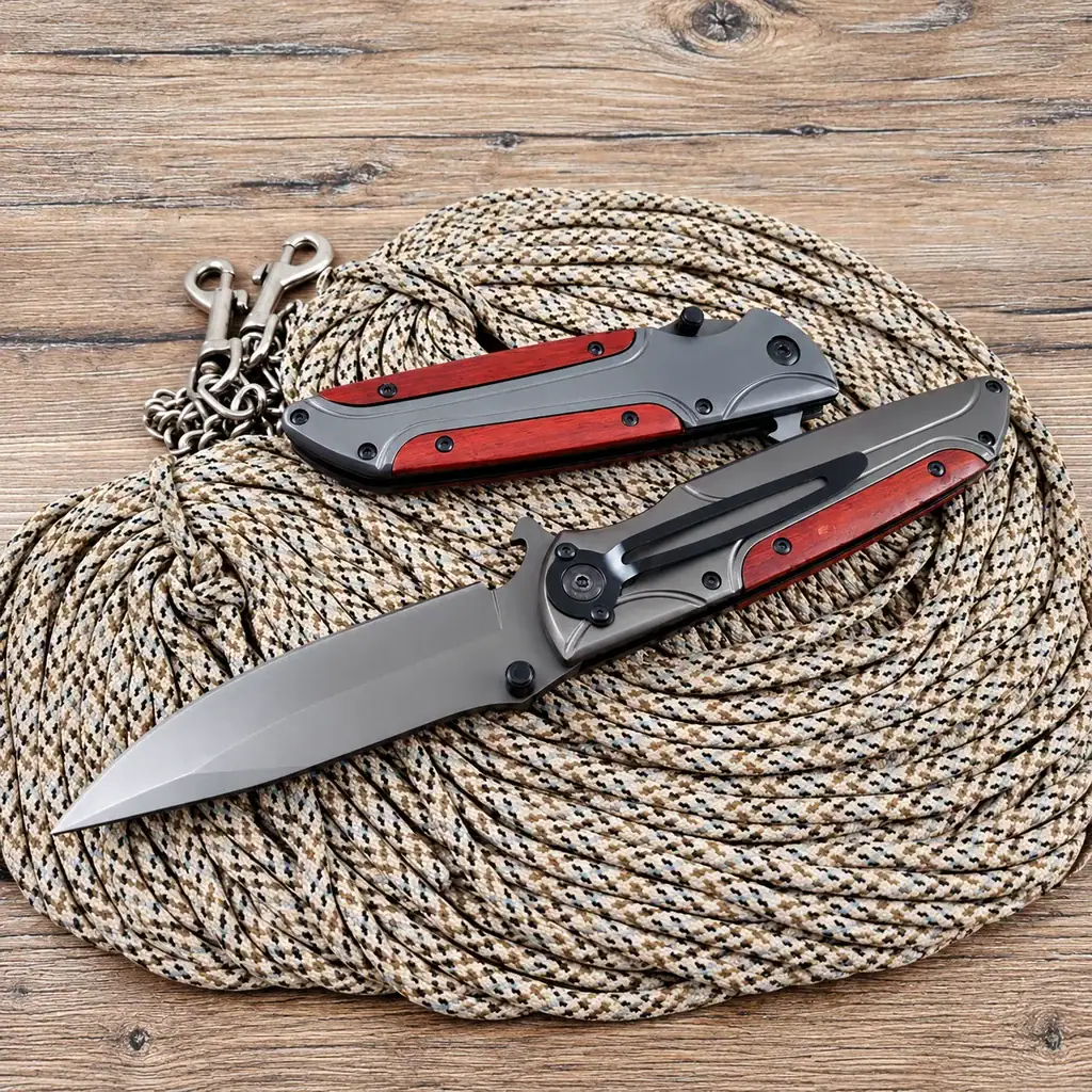 K21 Browning FA50 tactical folding knife with red handles and steel blade, outdoor gear for tactical use.