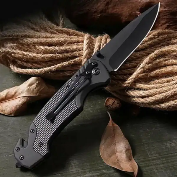 K17 VERGE All-Black tactical folding knife with glass breaker and rope cutter for outdoor survival.