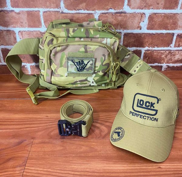 Camouflage tactical shoulder bag with patch, beige cap, and belt for outdoor use.