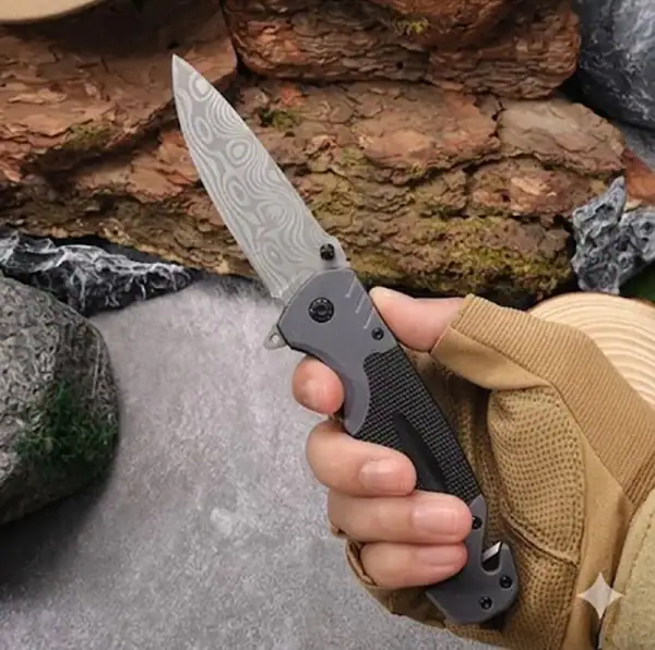 K08 Tactical Folding Knife with patterned blade and black handle for outdoor survival in Cambodia.