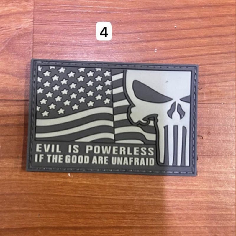 Evil skull patch with American flag design and the quote 'Evil is powerless if the good are unafraid'.