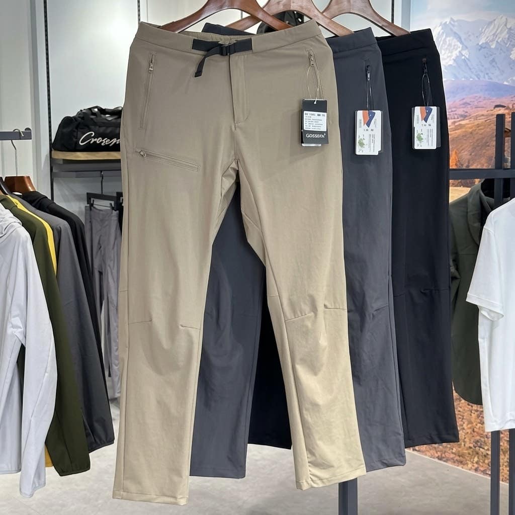 IX31 Men's Lightweight Softshell Outdoor Pants with built-in belt and zipper pockets in beige and dark colors.