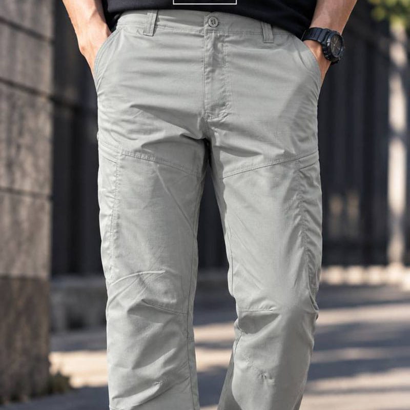Light gray IX33 tactical pants for outdoor, work, and daily wear, shown in a close-up of the lower torso and legs.