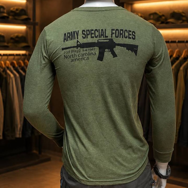 Green tactical long-sleeve shirt with US Army graphic and rifle print, military style, casual outdoor wear.
