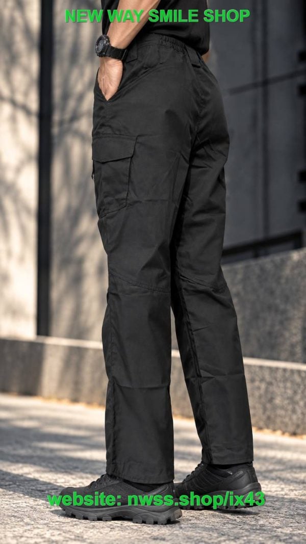 Black tactical cargo pants with utility pockets and D-ring details for outdoor and tactical use.