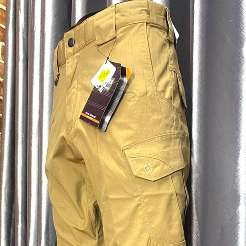 Khaki tactical cargo pants with multi-pocket design for outdoor use.