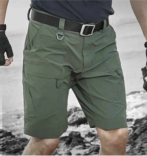 Lightweight tactical cargo shorts in olive green with multiple pockets and quick-dry fabric for outdoor activities.
