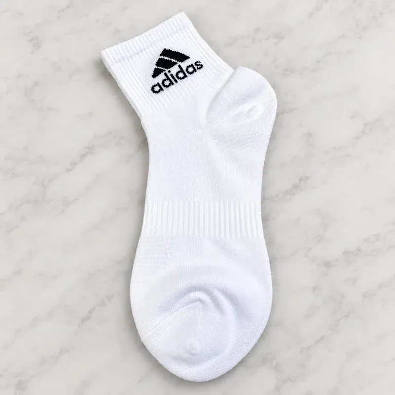 Adidas white sports socks with black logo, ideal for outdoor and tactical use.