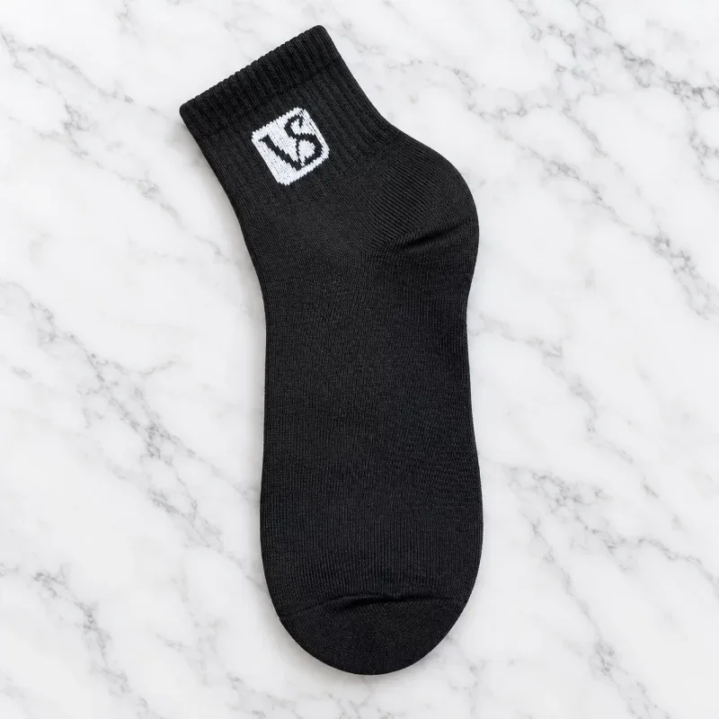 Black tactical sock for outdoor gear, lightweight and durable, ideal for tactical and outdoor use.