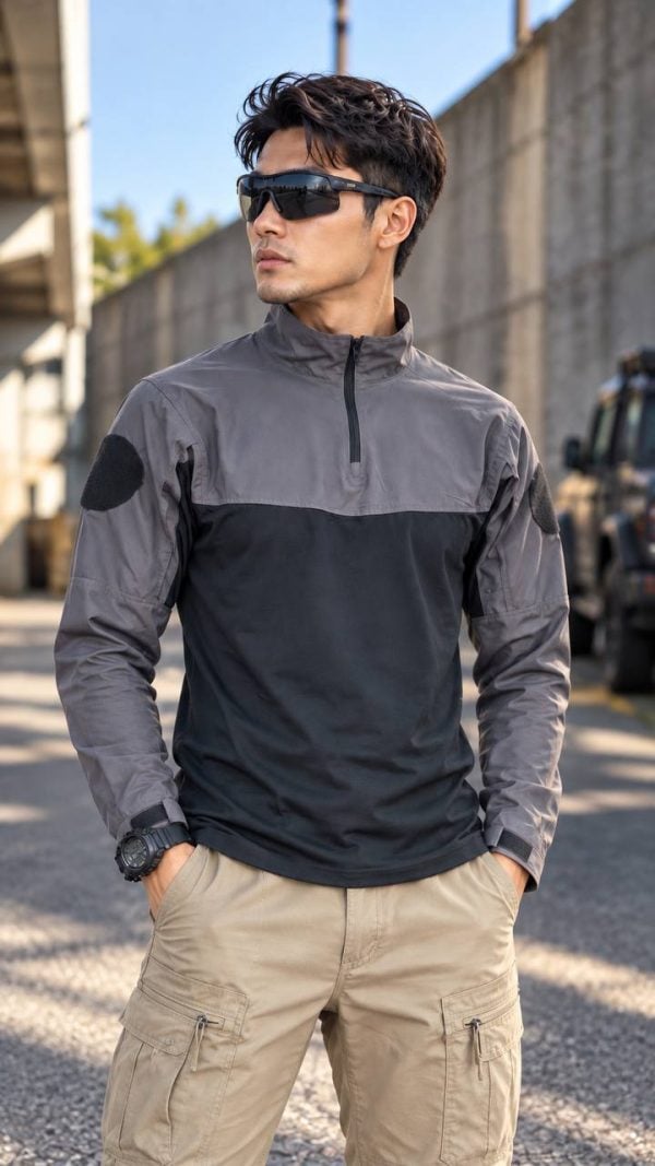 Tactical long-sleeve half-zip shirt with arm patch panels and adjustable cuffs in two-tone gray and black.