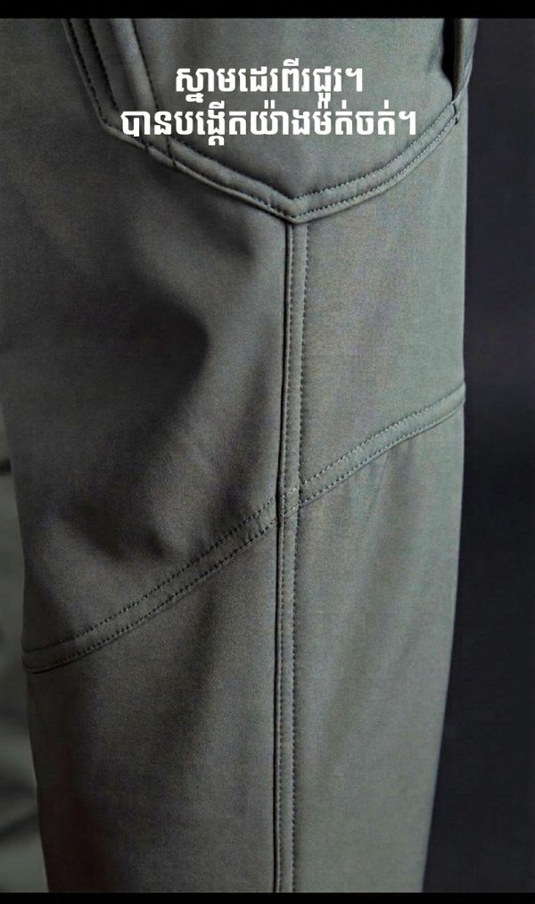 Tactical long sleeve shirt in olive green with dual chest pockets and wrinkle-resistant fabric.